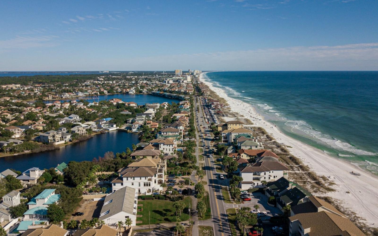 Aerial view of the Destin coastline, emerald water and white beaches