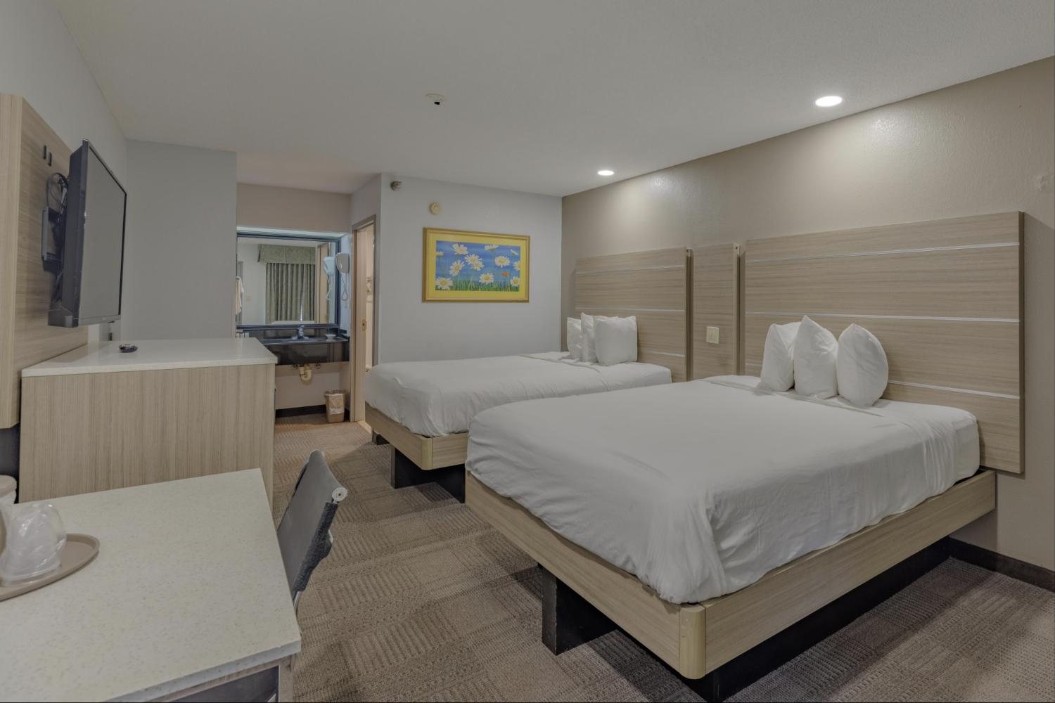 Double Queen room with two beds, desk and TV
