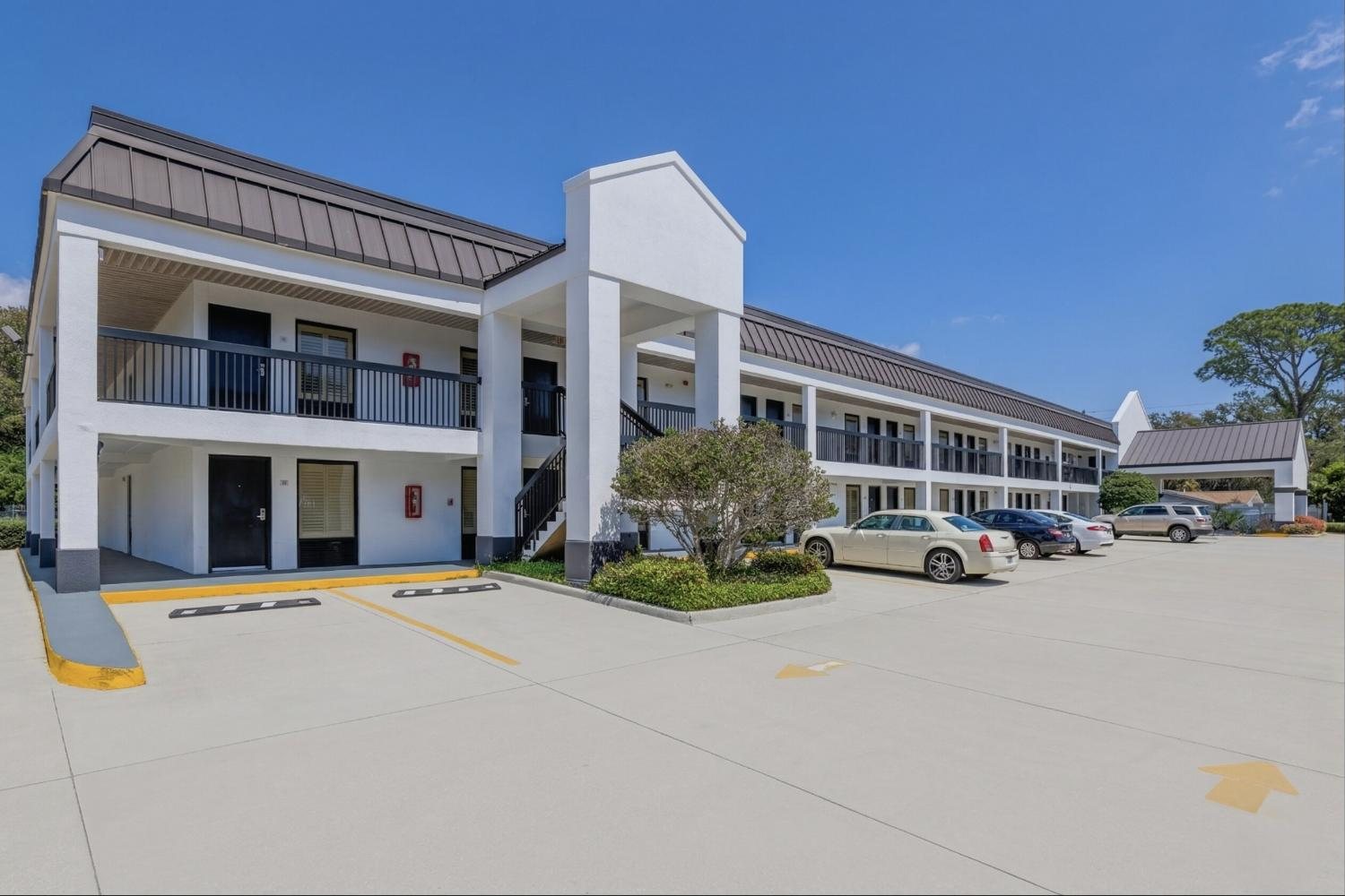 Two floors of rooms around the parking court