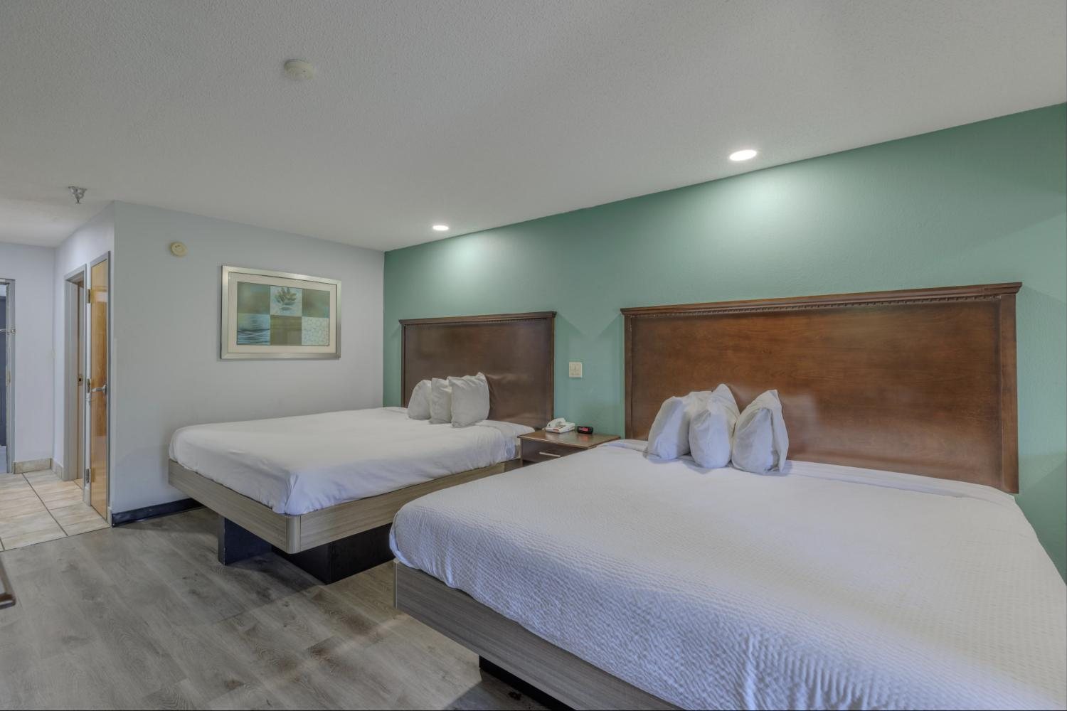 Double King Room with two king beds and a teal accent wall